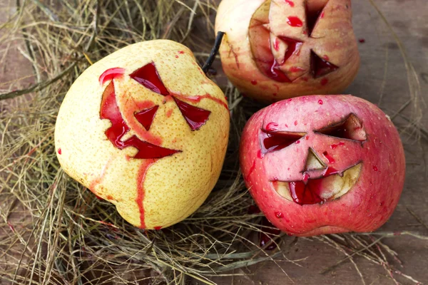 Chinese pear and apple for halloween on hay — Stock Photo, Image