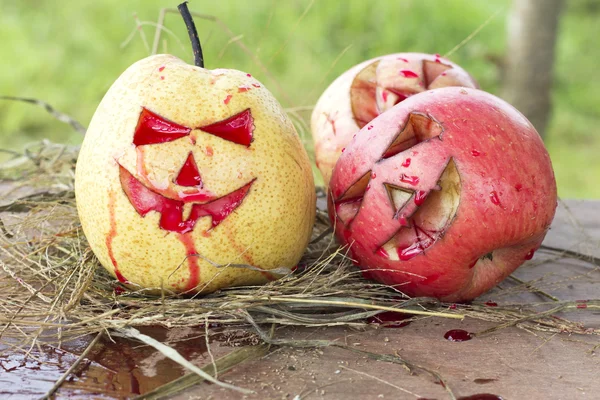 Chinese pear and apple for halloween on hay — Stock Photo, Image