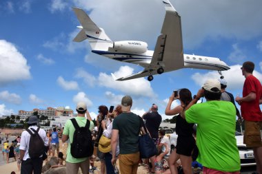 Jet landing over Maho Beach clipart