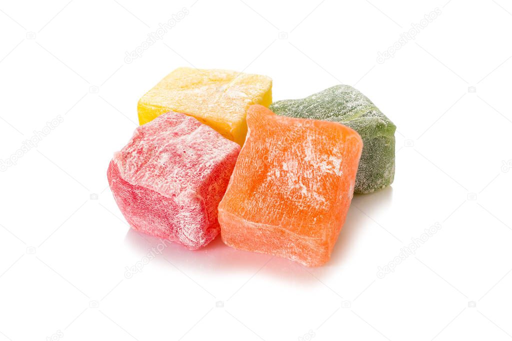 Turkish delight. Different types of rahat locum. Four colorful pieces of sweet oriental delights in powered sugar. Close-up view.