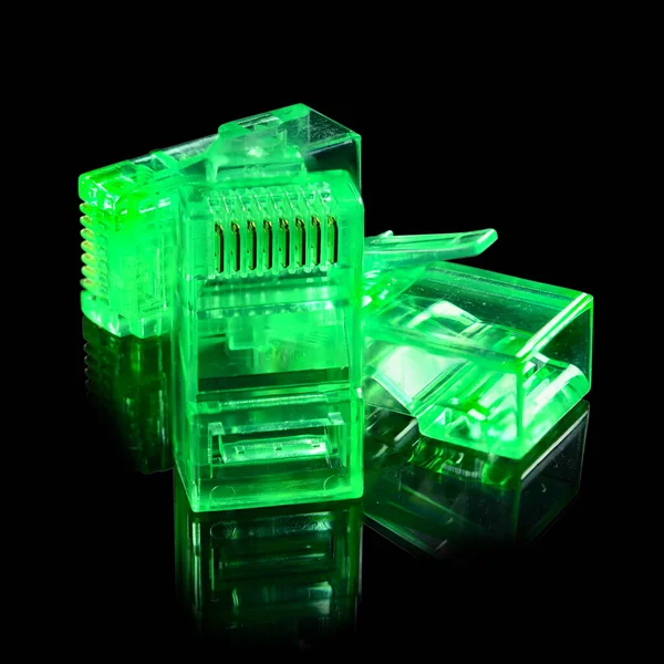 Connector rj-45. Three neon green transparent connectors rj45 for network and internet. Close up macro isolated on black background with reflection.