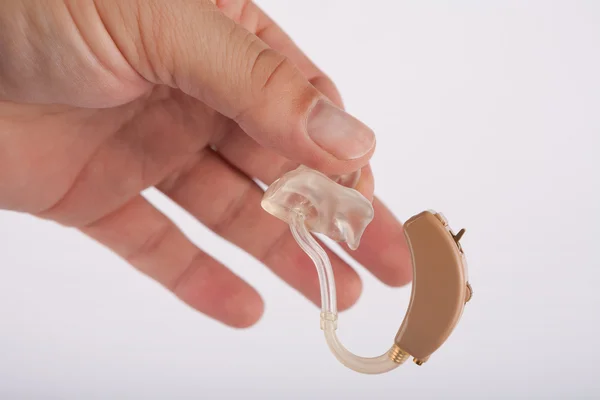 Hand holding a hearing aid — Stock Photo, Image