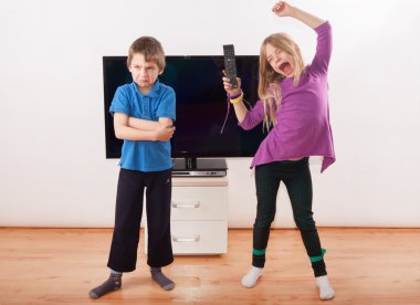 Kardeş elinde uzaktan kumanda ile