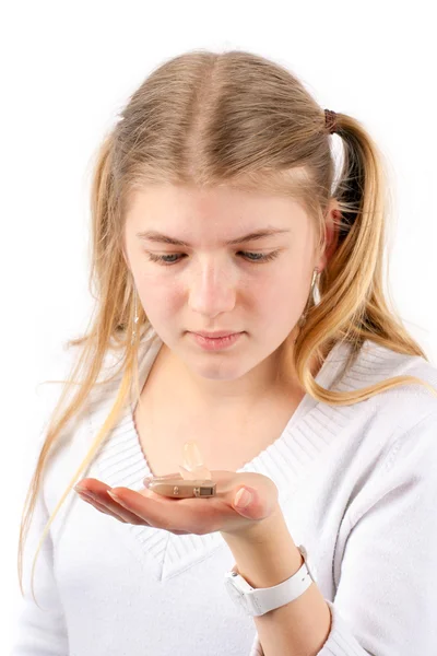 Girl holding hearing aid — Stock Photo, Image