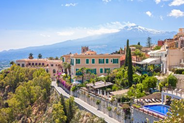 Taormina with Etna volcano in Italy clipart