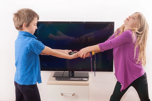 Fighting for the tv remote control — Stock Photo, Image