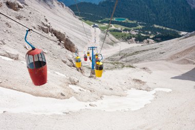 Red and yellow cable car in the Dolomite Mountains clipart