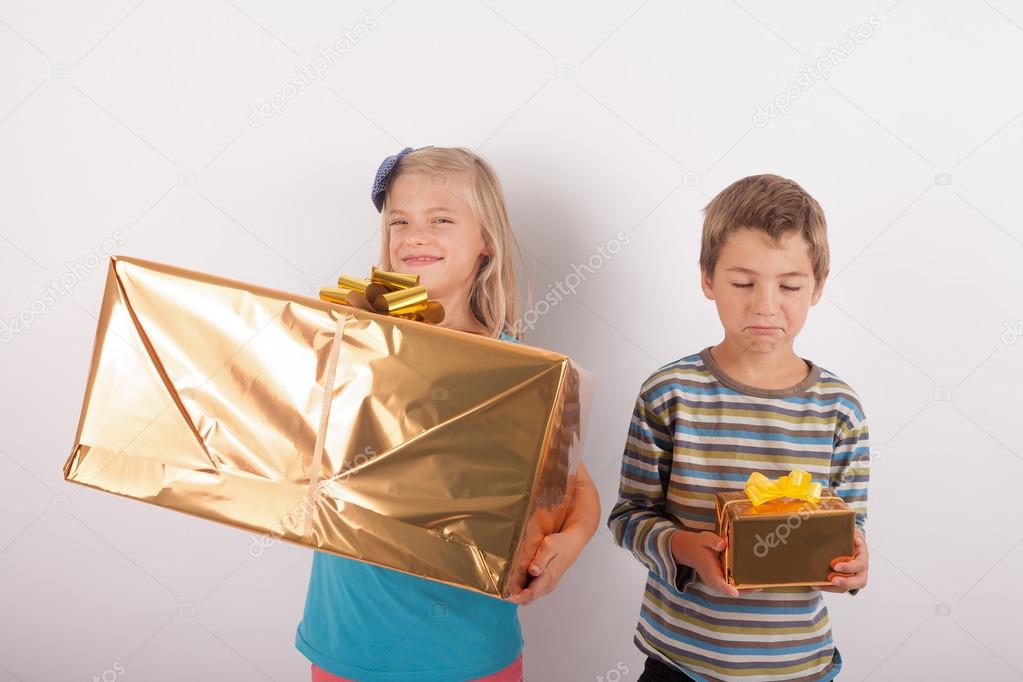 Siblings comparing their presents