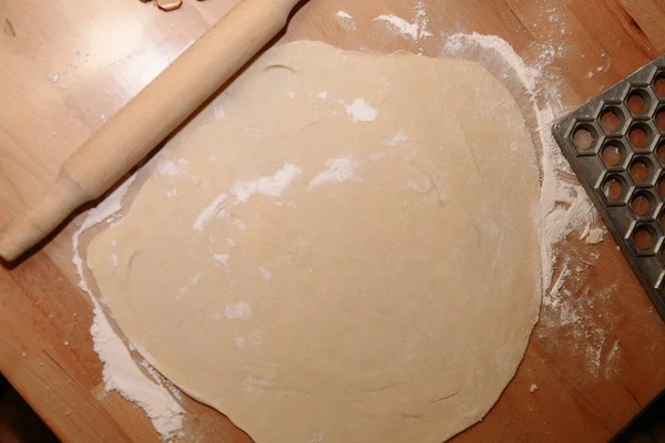 Woman sculpts homemade dumplings bear ears in the kitchen. Modeling dumplings closeup. Female hands sculpt dumplings. — Stock Photo, Image