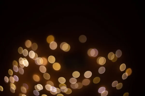 Siyah arkaplandaki altın soyut bokeh, parlak ışıklar