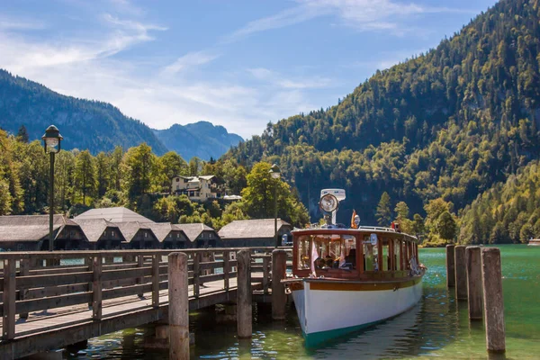 An electric boat on the Konigsee in Germany stands on a dock, a tourist spot, a vacation spot and beautiful alpine scenery, Bavaria Germany