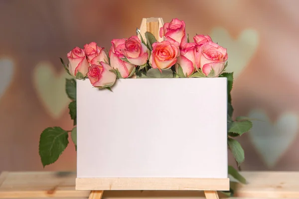 Ahşap bir arka planda pembe güller, yazı için beyaz bir yer, sehpa, 14 Şubat veya 8 Mart bayramı için pembe arka plan, Sevgililer Günü
