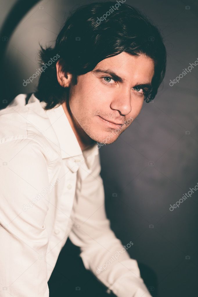 Romantic young man in a white shirt .