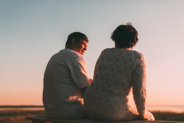 Evli bir çift bir bankta oturan bir siluet geri görüntülemek.