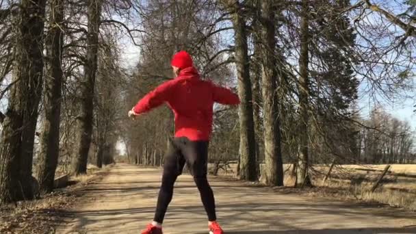 Man the athlete does exercises on opened air before run. — Stock Video