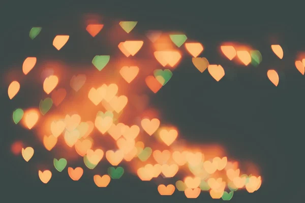 Many orange hearts on a dark background. — Stock Photo, Image