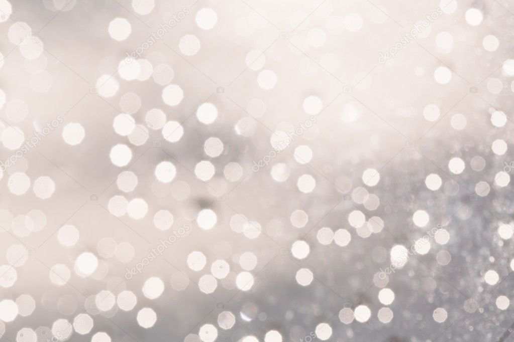Silver background with glowing blurred circles.