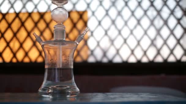 Camera moves from right to left and removes trendy glass hookah. — Stock Video