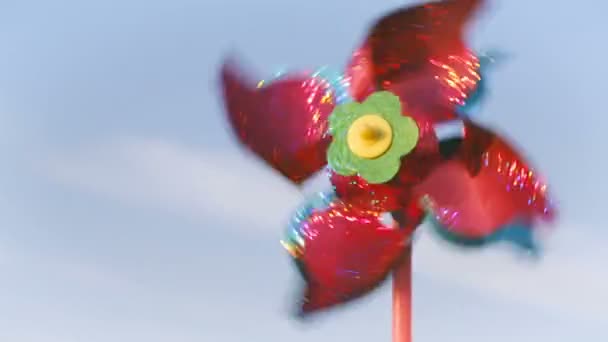 Colorful windmill turns against the blue sky. — Stock Video