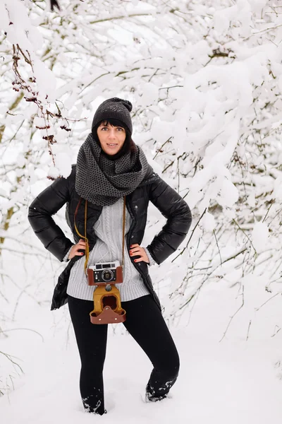 Beautiful brunette girl with a vintage camera — Stock Photo, Image