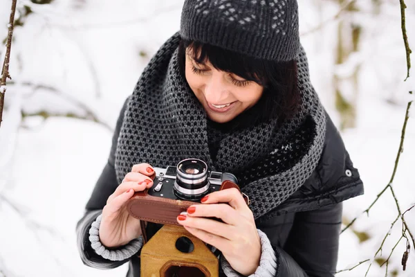 Beautiful brunette girl with a vintage camera — Stock Photo, Image