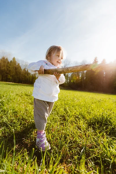 Little girl with a stick — Stock Photo, Image