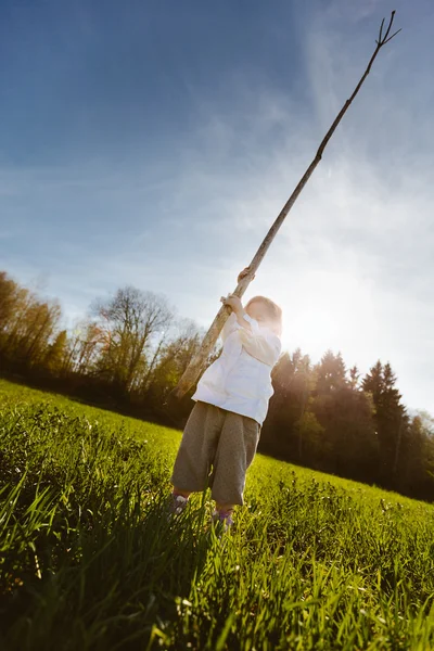 Little girl with a stick — Stock Photo, Image