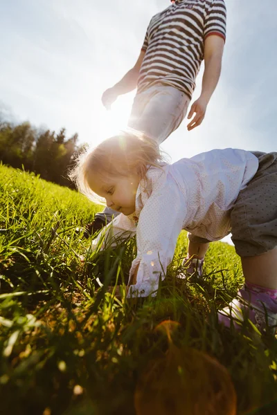 Little girl on all fours in the park Stock Photo