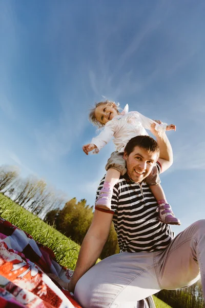 Dad with a daughter on his shoulders laughing — Stock Photo, Image