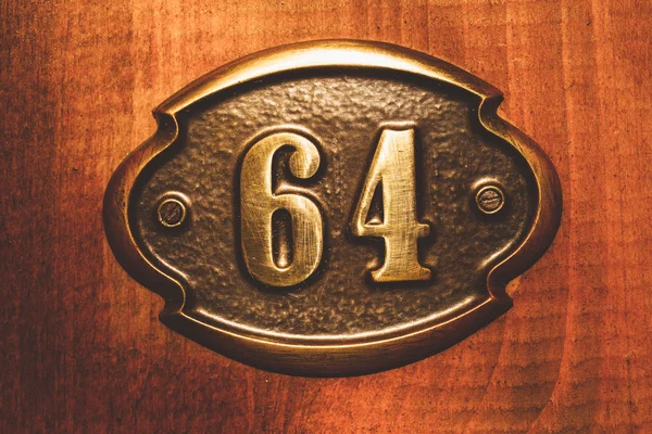 Apartment number sixty four close up photo. — Stock Photo, Image