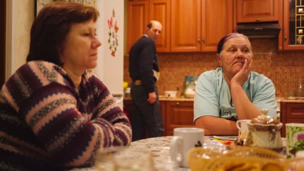 Adultos tristes sentados a la mesa hablando . — Vídeos de Stock