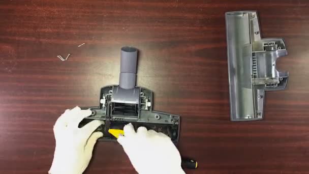 Hands in white gloves clear and repair a nozzle from the vacuum cleaner. — Stock Video