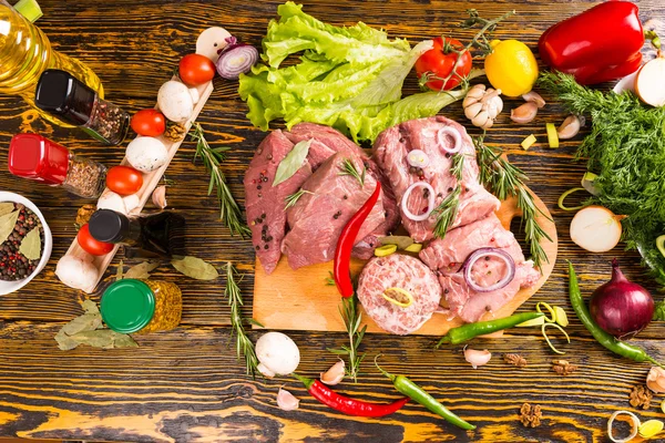 Загроможденный стол из мяса и овощей — стоковое фото