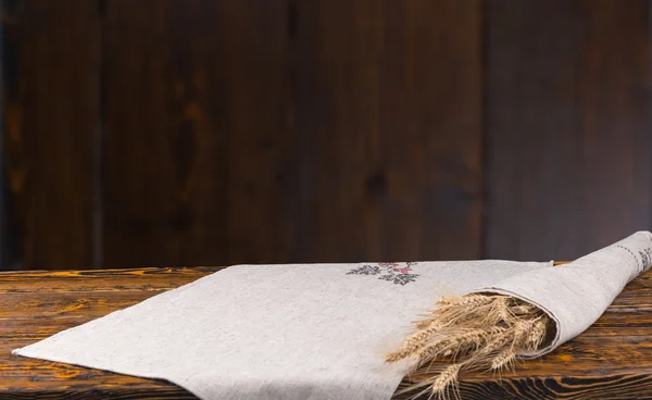 Oreilles fraîches de blé mûr sur une table rustique — Photo