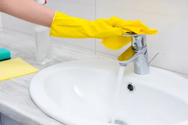 Close up of gloved hand working sink faucet — Stock Photo, Image