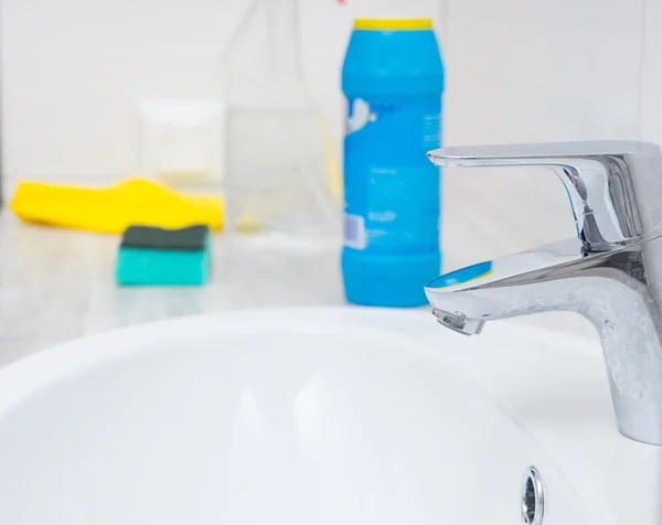 Close up of sink spigot and cleaning objects — Stock Photo, Image