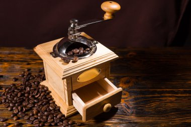 Hand crank coffee grinder with scattered beans
