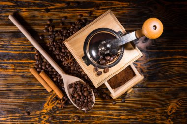 Top down view on coffee grinder and spoon