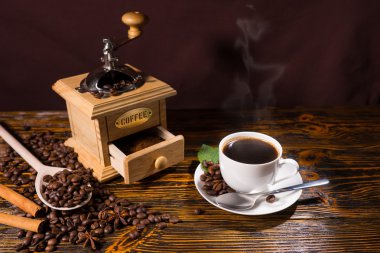Cup of Coffee with Hand Grinder and Roasted Beans