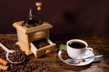 Cup of Coffee with Hand Grinder and Roasted Beans