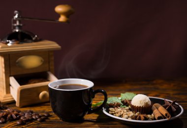 Cup of Coffee with Grinder and Plate of Garnishes