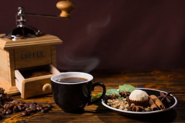 Cup of Coffee with Grinder and Plate of Garnishes