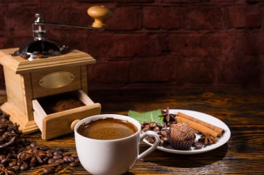 Open grinder with powder against dark background