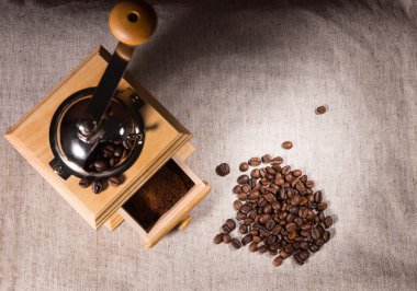 Coffee grinder, ground and beans on cloth