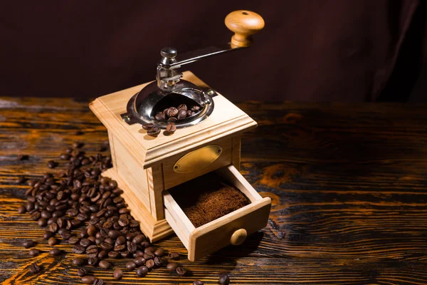 Coffee grinder with finished grounds and beans — Stock Photo, Image