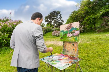 Orta yaşlı moda erkek ressam renkleri karıştırma 