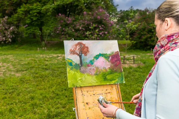 Widok z boku kobiece malarza, praca w lesie — Zdjęcie stockowe
