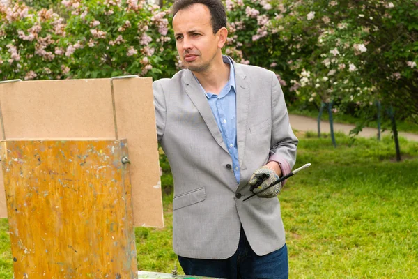 Melancholy male artist painting a masterpiece — Stock Photo, Image