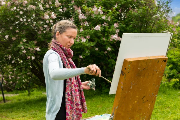 Portrait of a middle-aged female artist in the process — Stock Photo, Image
