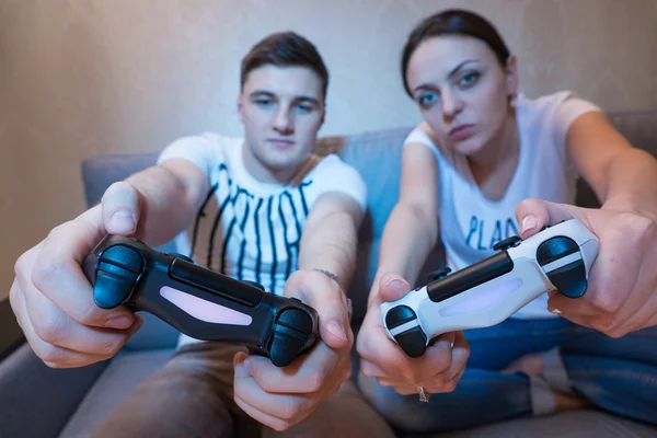 Young attractive couple simulating the game steering movement si — Stockfoto